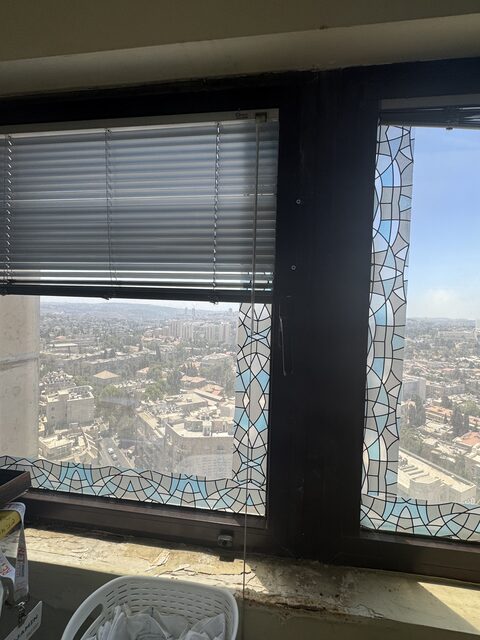 The dining room window, its sill crumbling, opening onto a twenty-storey drop